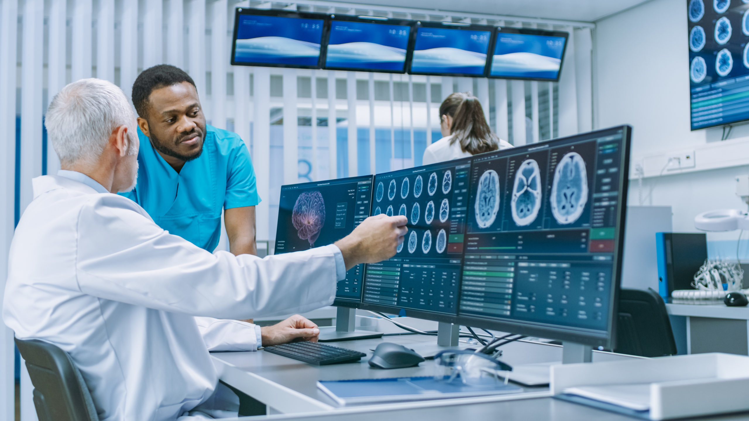 Medical Scientist and Surgeon Discussing CT / MRI Brain Scan Images on